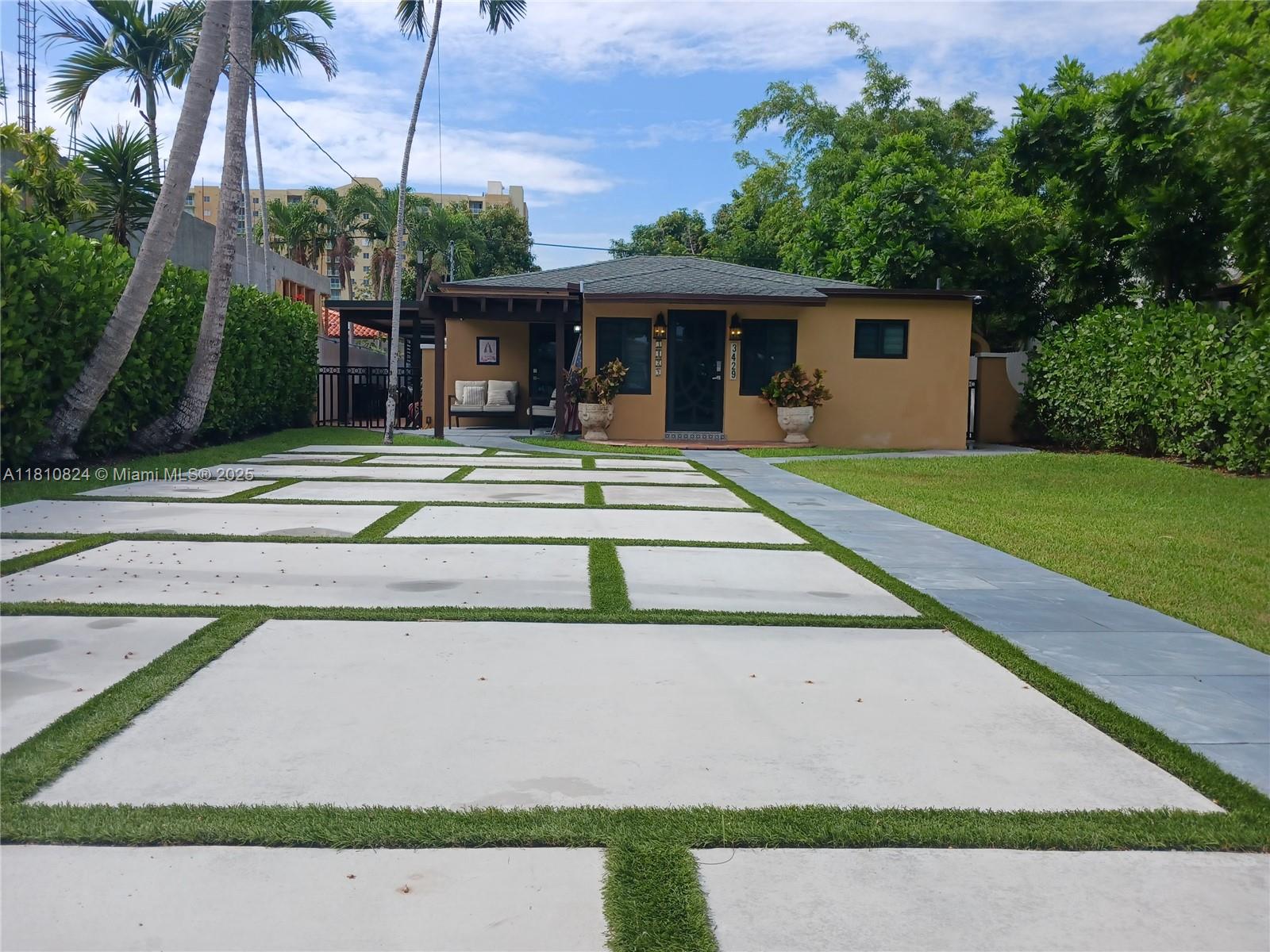 3429 Southwest 23rd Terrace Miami, FL 33145 - Photo 2 of 32 a view of a house with a yard and palm trees