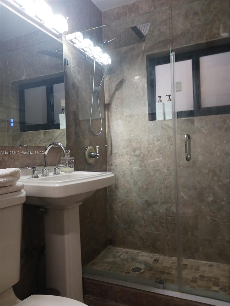 3429 Southwest 23rd Terrace Miami, FL 33145 - Photo 22 of 32 a bathroom with a sink shower and a mirror