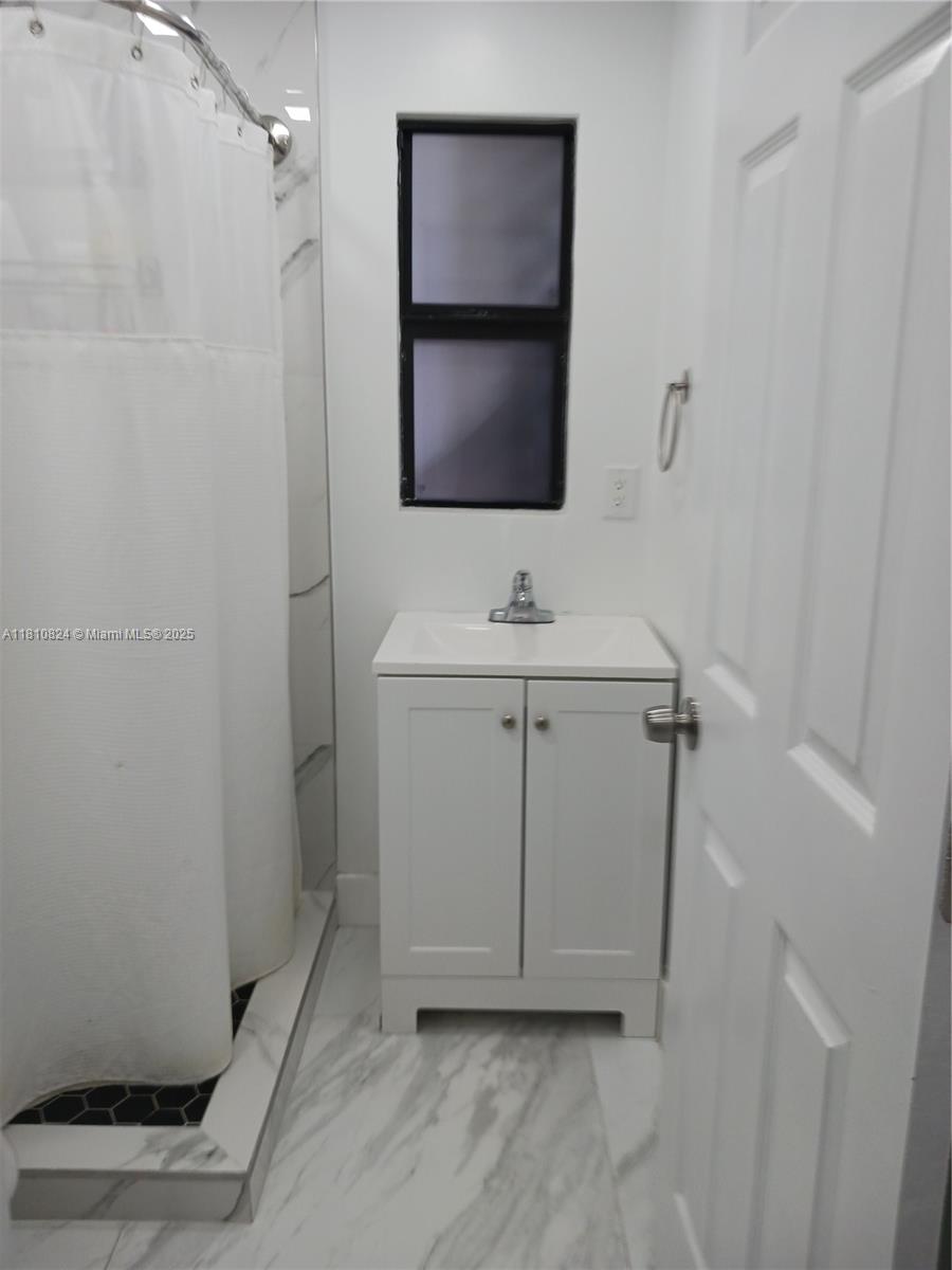 3429 Southwest 23rd Terrace Miami, FL 33145 - Photo 24 of 32 a bathroom with a sink and a mirror
