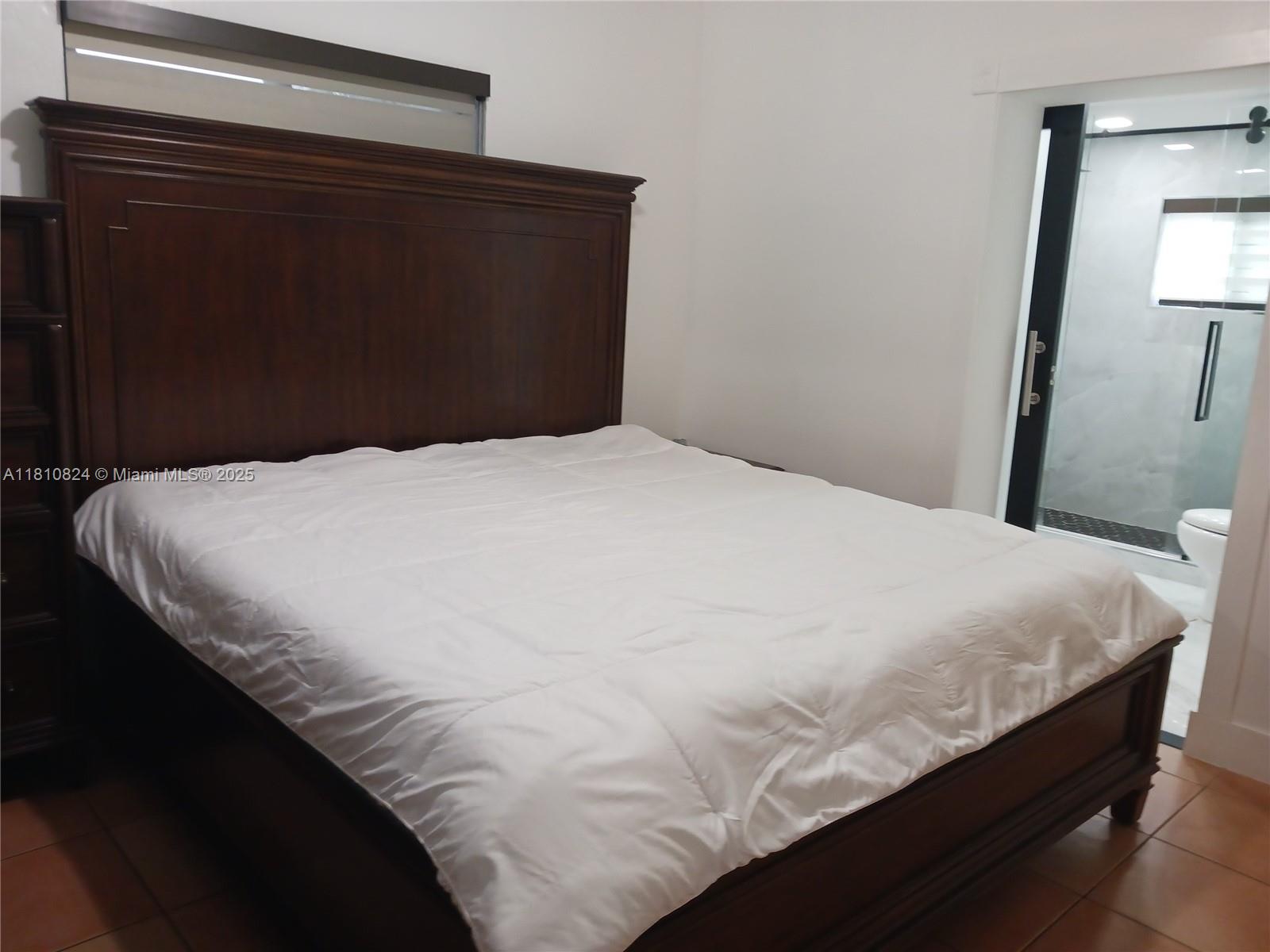 3429 Southwest 23rd Terrace Miami, FL 33145 - Photo 27 of 32 a bedroom with a bed and mirror
