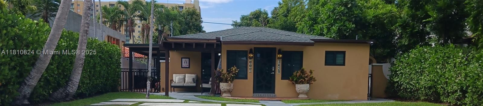 3429 Southwest 23rd Terrace Miami, FL 33145 - Photo 3 of 32 a front view of a house with a garden