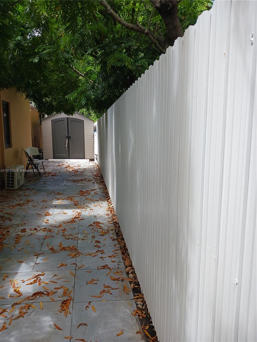 3429 Southwest 23rd Terrace Miami, FL 33145 - Photo 32 of 32 a backyard of a house with lawn chairs and wooden fence