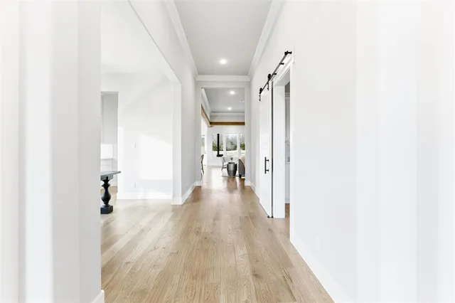 a view of a hallway with wooden floor