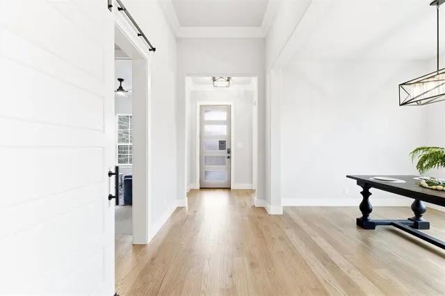 a view of a room with wooden floor lounge chair and windows