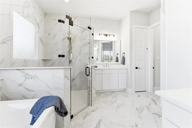 a bathroom with a bathtub sink and mirror