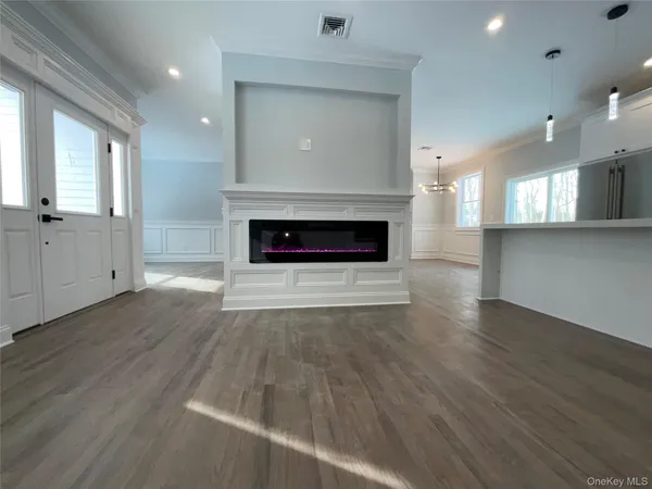 a kitchen with stainless steel appliances kitchen island granite countertop a stove a sink and a microwave