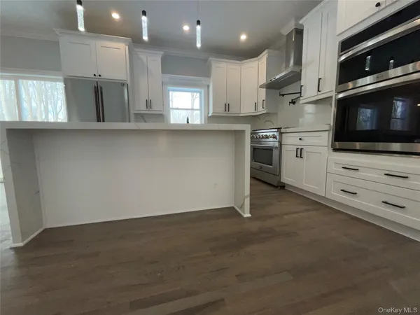 a kitchen with a sink a stove and cabinets