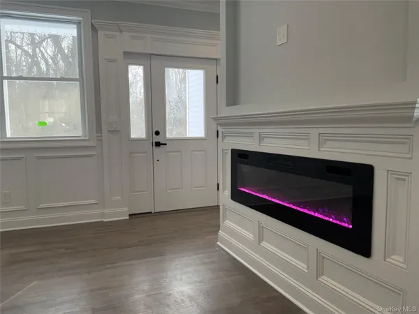 a view of a big room with wooden floor and windows