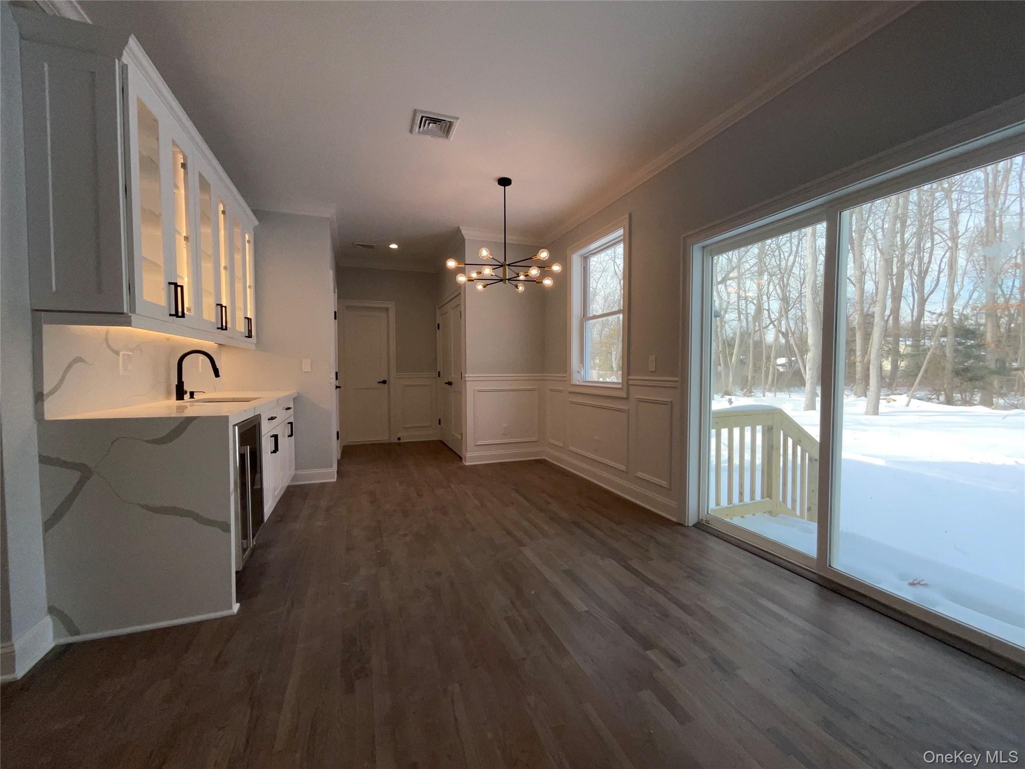 89 B Mount Sinai-Coram Road Coram, NY 11727 - Photo 9 of 22 a view of a big room with wooden floor and windows