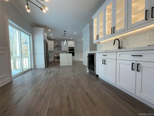 a kitchen with a sink cabinets and a window