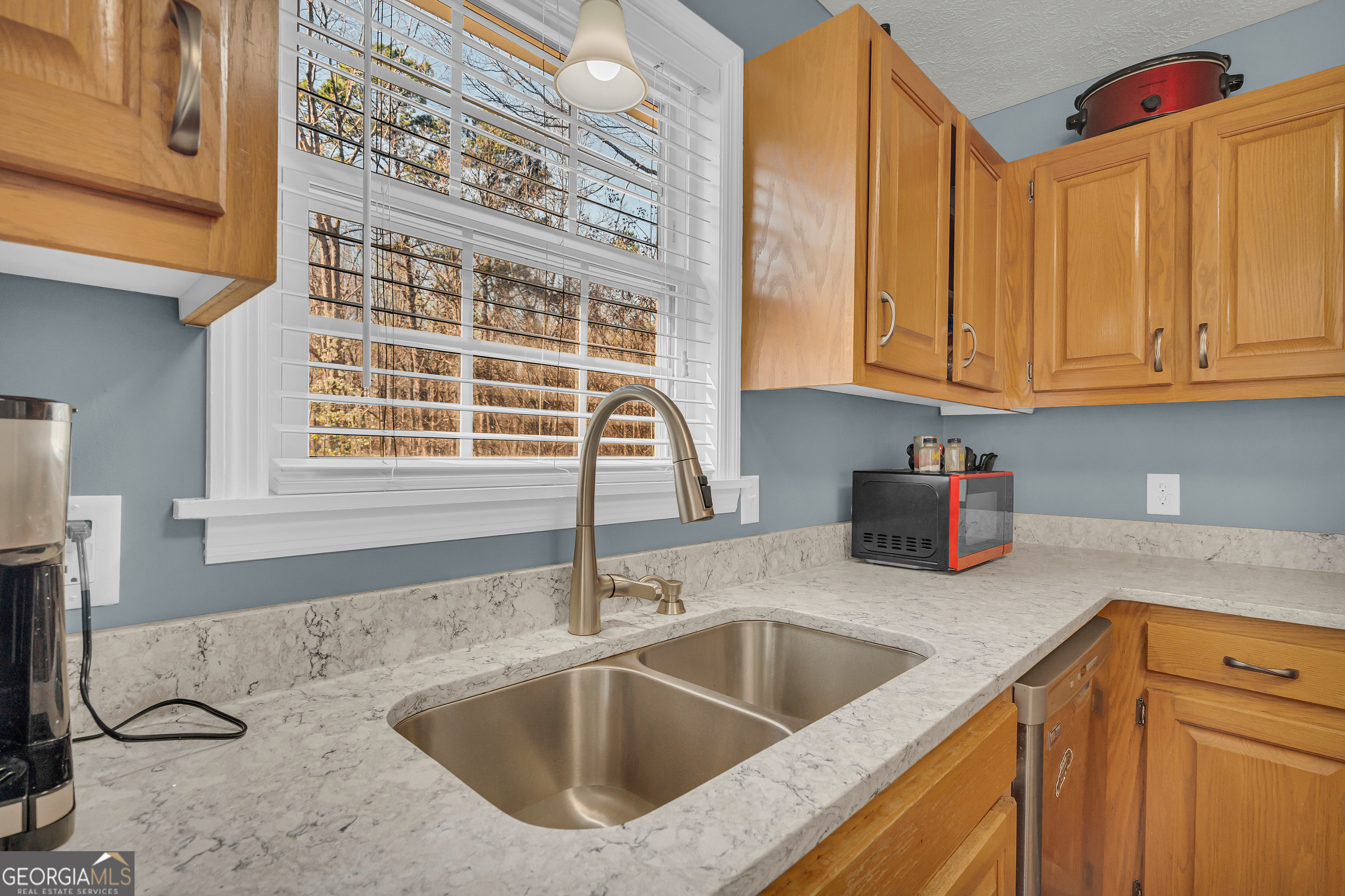 415 Ivory Drive Baldwin, GA 30511 - Photo 19 of 57 a kitchen with granite countertop a sink and a window