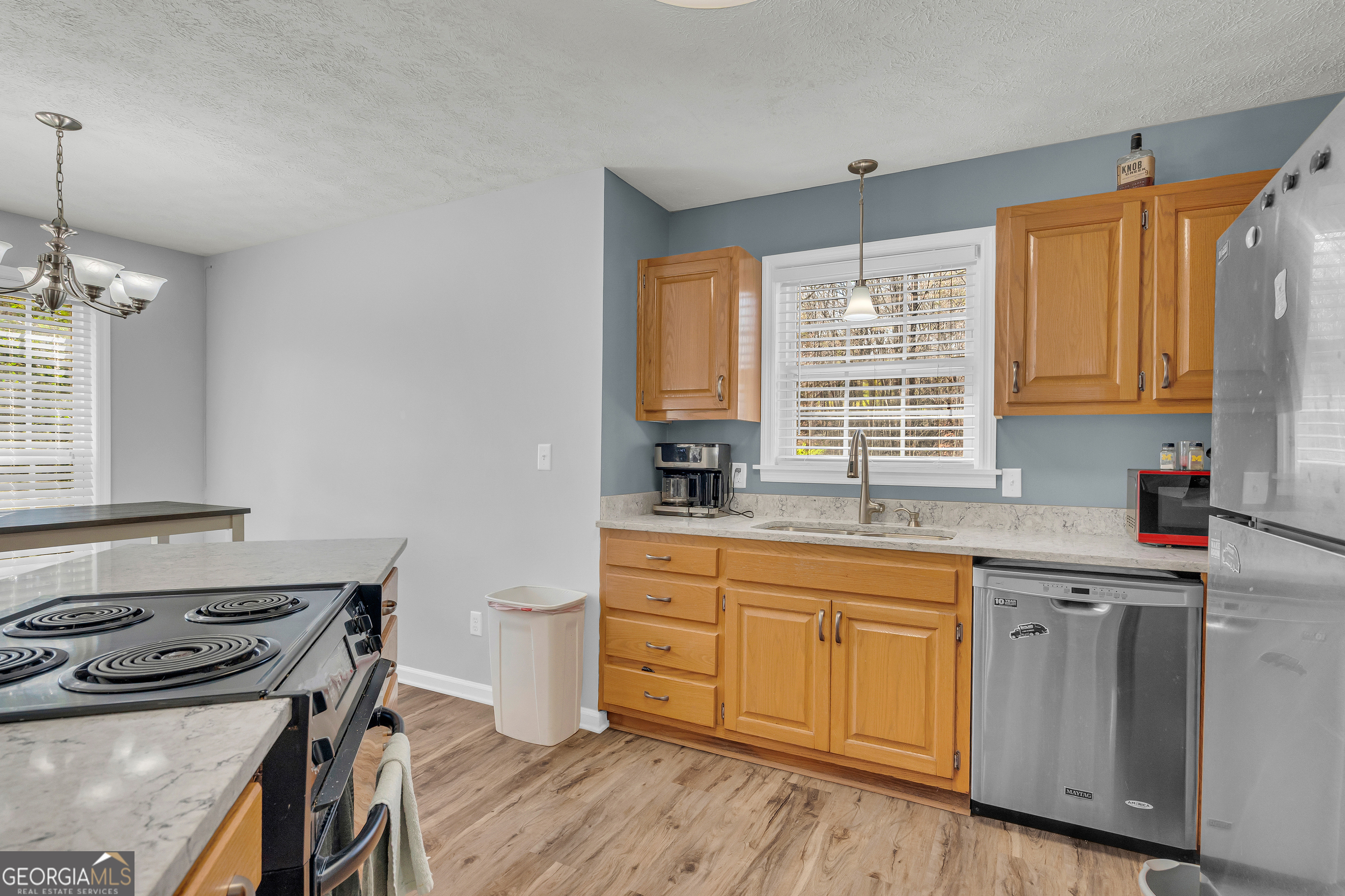 415 Ivory Drive Baldwin, GA 30511 - Photo 21 of 57 a kitchen with a stove a sink and wooden floor