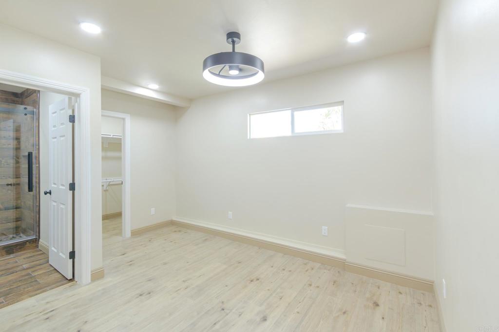 1174 Sea Strand Lane San Diego, CA 92154 - Photo 12 of 32 an empty room with wooden floor and windows