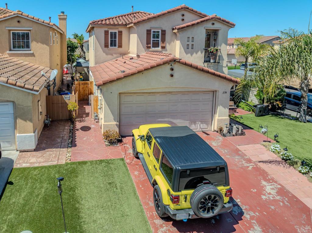 1174 Sea Strand Lane San Diego, CA 92154 - Photo 24 of 32 a aerial view of a house with a yard and furniture