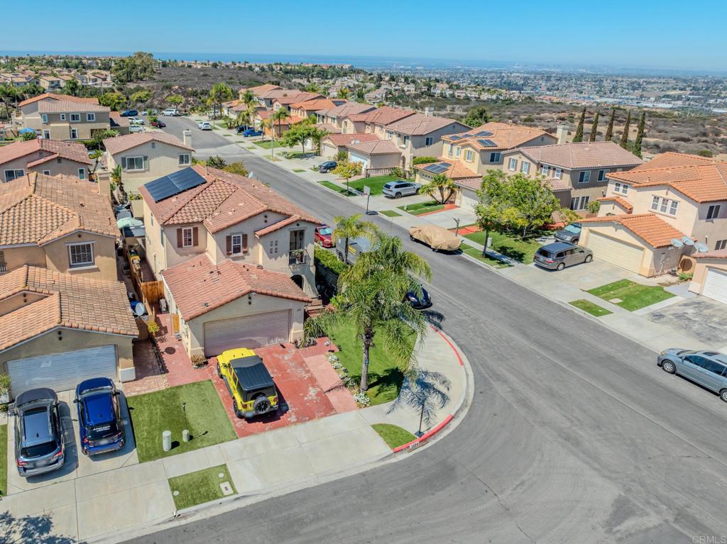 1174 Sea Strand Lane San Diego, CA 92154 - Photo 26 of 32 an aerial view of residential houses with outdoor space and parking
