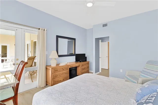 a bedroom with a bed and a view of kitchen