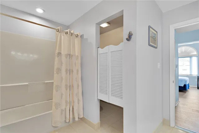 a bathroom with a shower and a glass door