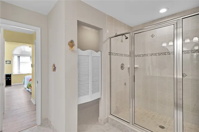 a bathroom with a shower and a glass door