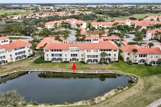 an aerial view of residential houses with outdoor space and river