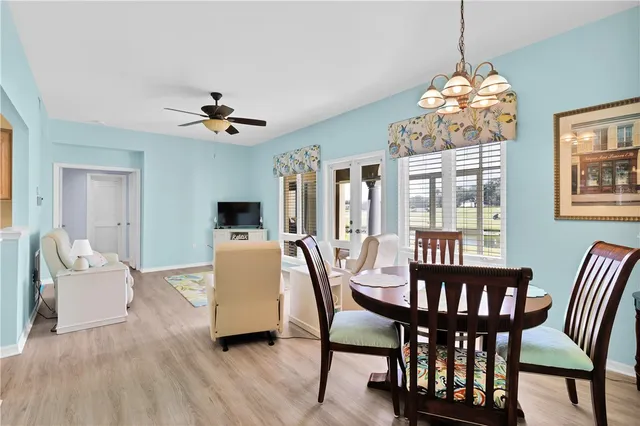 a view of a dining room with furniture wooden floor and chandelier
