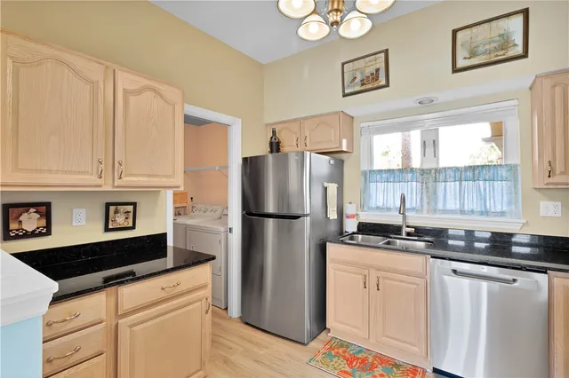 a kitchen with stainless steel appliances a refrigerator sink and cabinets