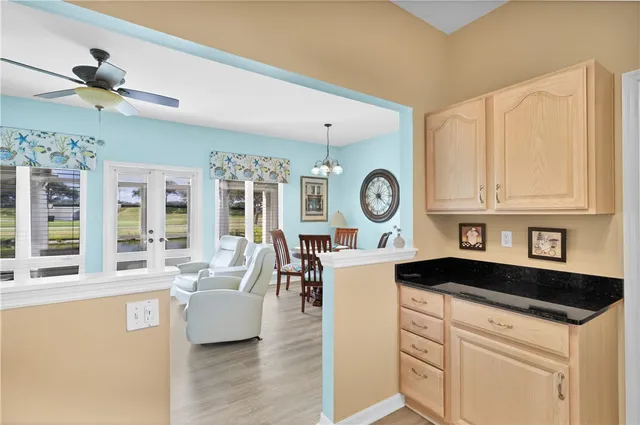 a living room with granite countertop furniture a clock and a window