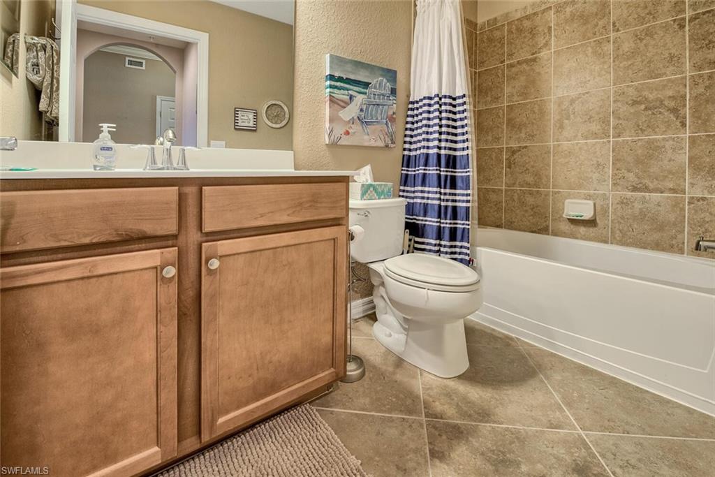 9715 Acqua Court, Unit 116 Naples, FL 34113 - Photo 11 of 33 a bathroom with a sink toilet and shower