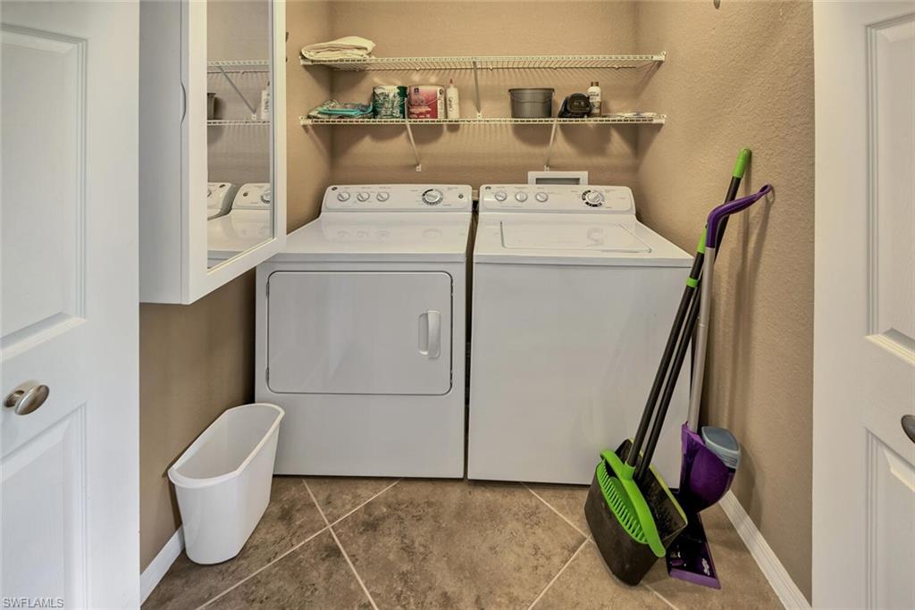 9715 Acqua Court, Unit 116 Naples, FL 34113 - Photo 12 of 33 a utility room with dryer and washer