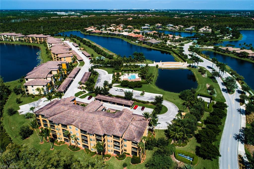 9715 Acqua Court, Unit 116 Naples, FL 34113 - Photo 15 of 33 an aerial view of swimming pool with outdoor seating and city view