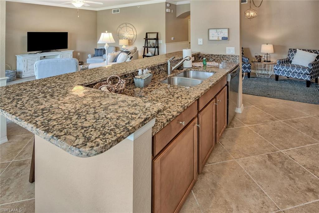 9715 Acqua Court, Unit 116 Naples, FL 34113 - Photo 3 of 33 a bathroom with sink and mirror