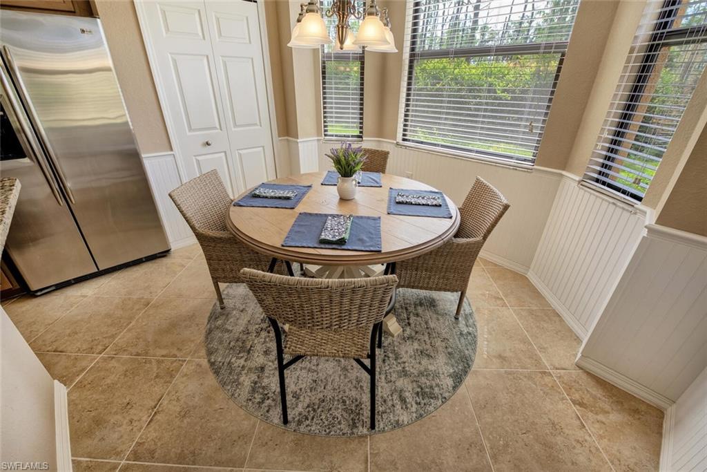 9715 Acqua Court, Unit 116 Naples, FL 34113 - Photo 5 of 33 a view of a dining room with furniture and a window