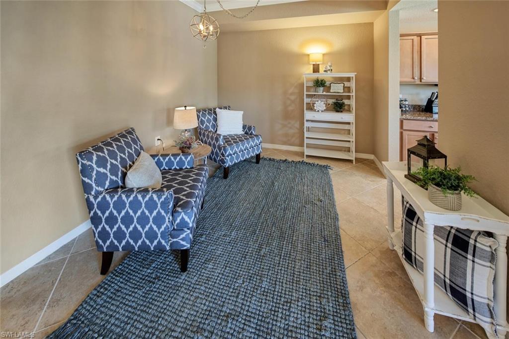 9715 Acqua Court, Unit 116 Naples, FL 34113 - Photo 6 of 33 a living room with furniture and a wooden floor