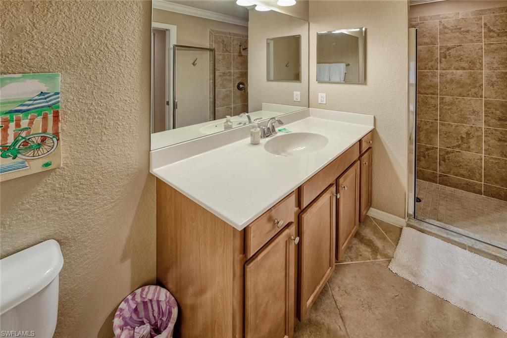 9715 Acqua Court, Unit 116 Naples, FL 34113 - Photo 9 of 33 a bathroom with a sink a toilet and shower