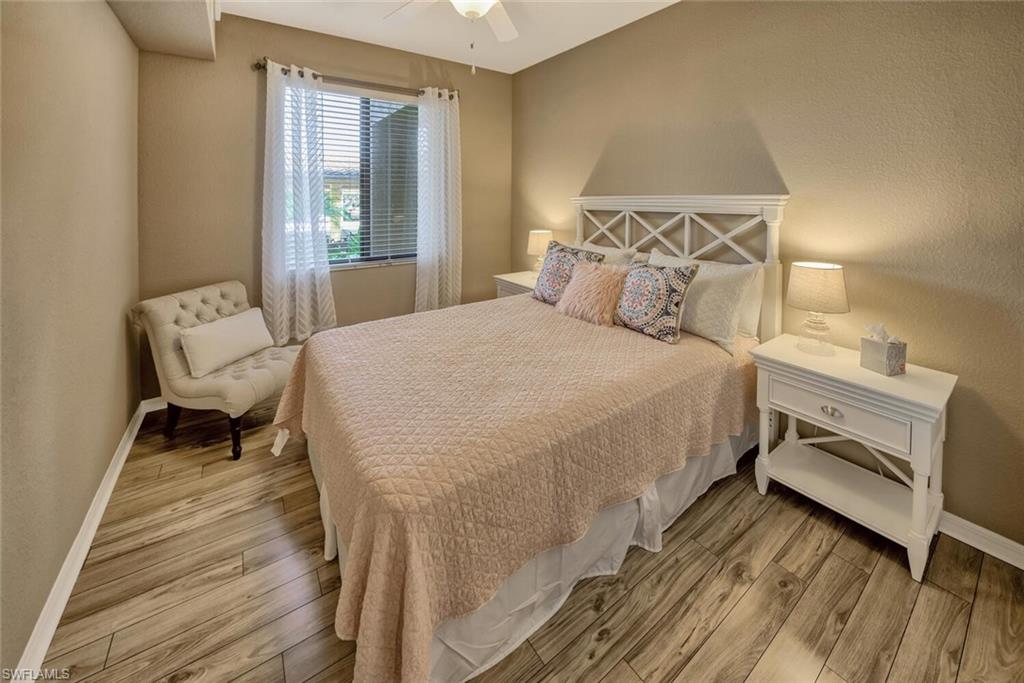 9715 Acqua Court, Unit 116 Naples, FL 34113 - Photo 10 of 33 a bedroom with a bed chair and a window
