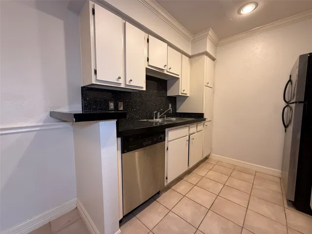 a kitchen with stainless steel appliances granite countertop a stove a refrigerator and a microwave