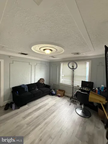 a bedroom with furniture and a large window