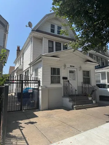 a front view of a house with a glass windows and yard