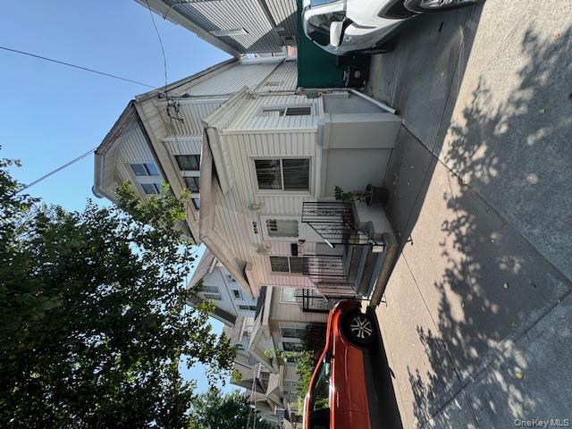 8540 98th Street Queens, NY 11421 - Photo 3 of 7 a front view of a house with cars parked