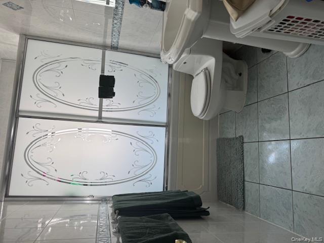 8540 98th Street Queens, NY 11421 - Photo 5 of 7 a bathroom with a toilet a sink and a mirror