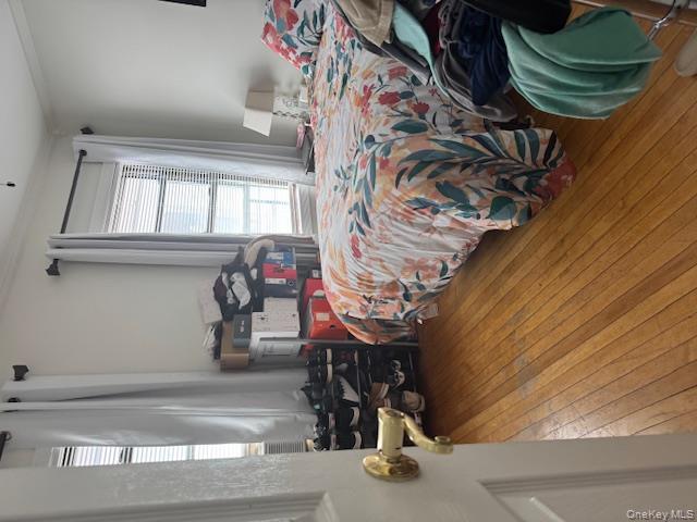 8540 98th Street Queens, NY 11421 - Photo 6 of 7 a bedroom with a bed and a window