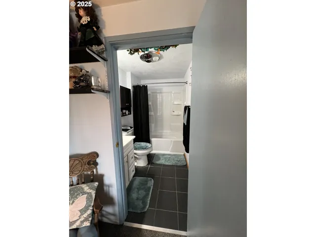 a living room with furniture and floor to ceiling window