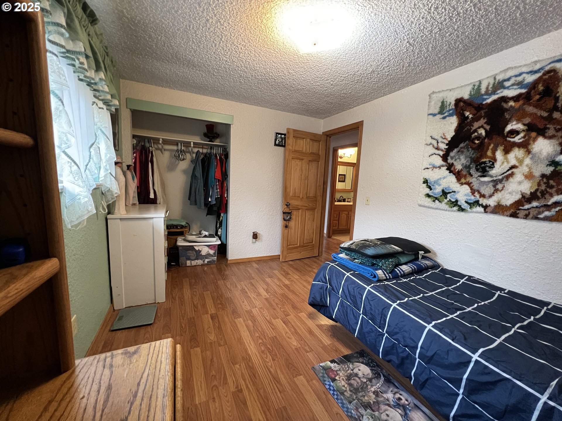 304 Hillcrest Drive John Day, OR 97845 - Photo 16 of 38 a bedroom with a bed and a wooden floor