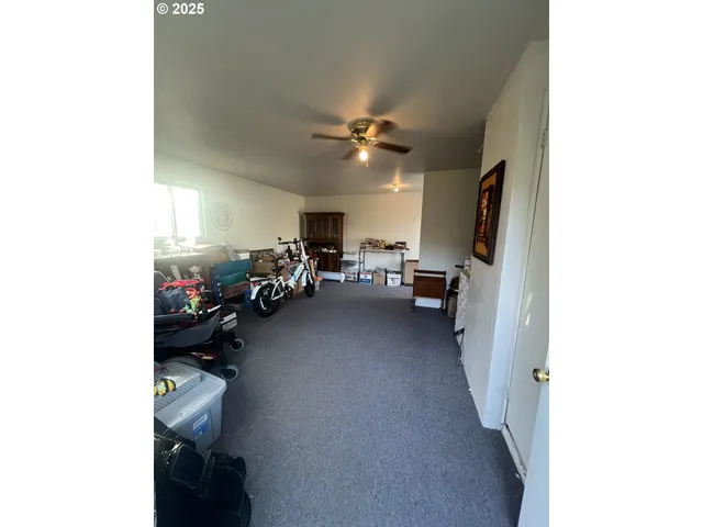 a view of a livingroom with furniture and a ceiling fan