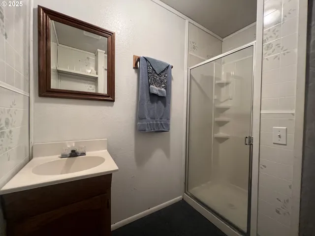 a bathroom with a shower and a sink
