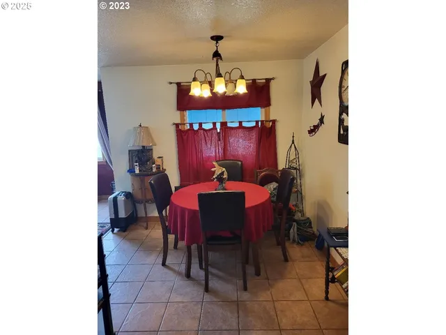 a view of a dining room with furniture and chandelier