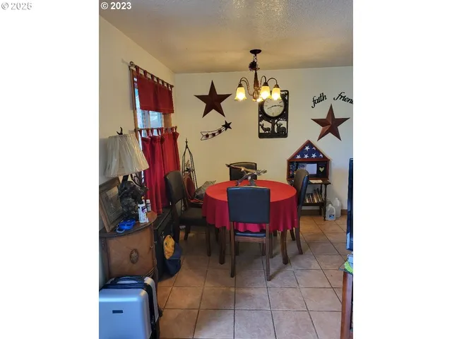 a view of a dining room with furniture and a chandelier