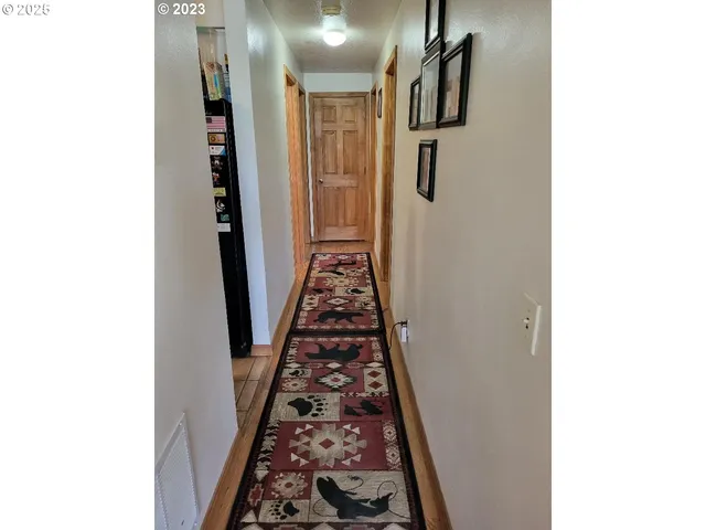 a view of hallway with wooden floor