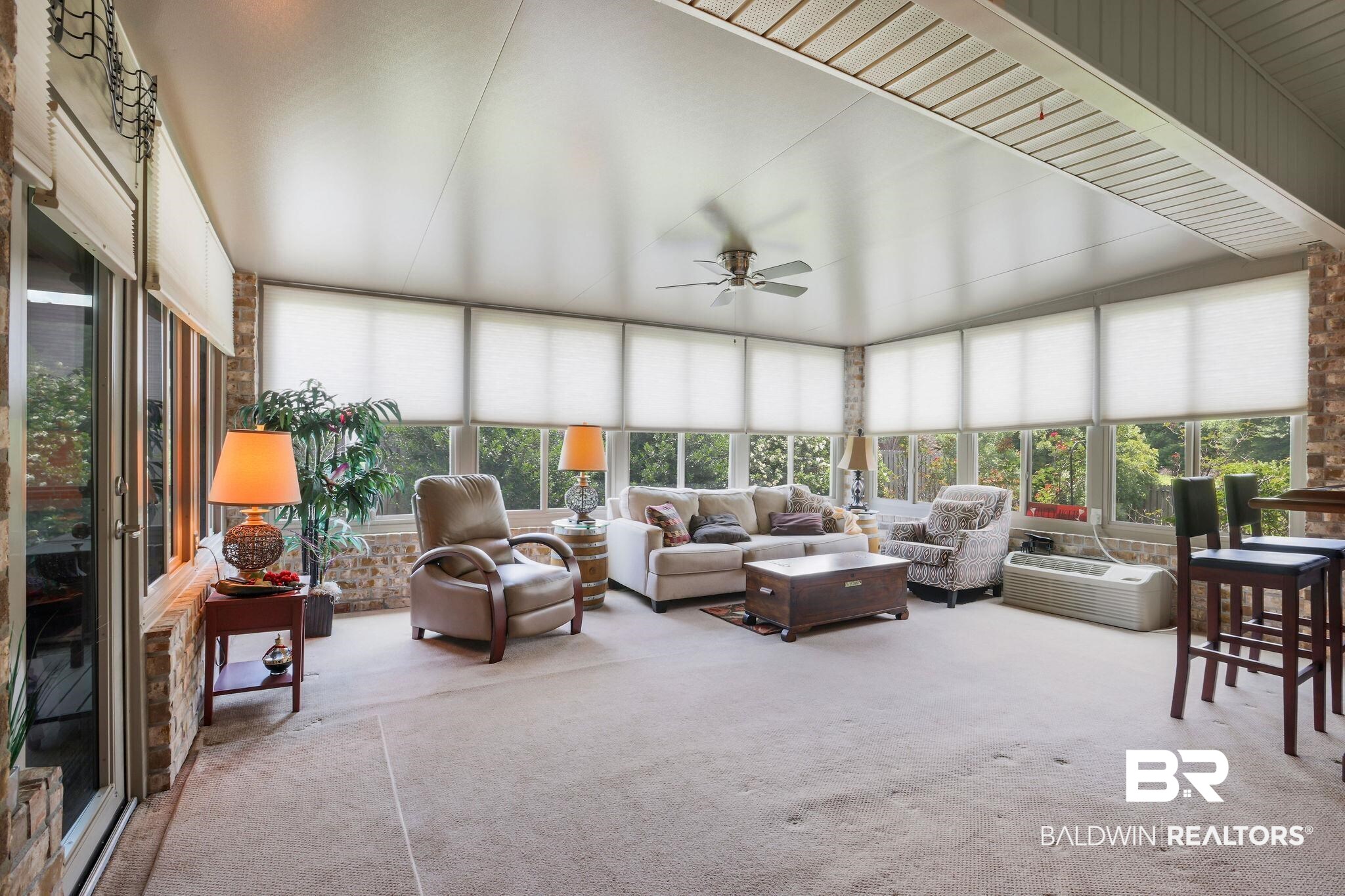 1090 Destin Avenue Foley, AL 36535 - Photo 21 of 30 Sunroom with a ceiling fan, carpet floors, and an outdoor hangout area