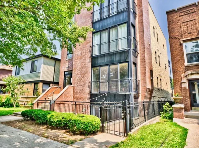 front view of a brick house with a yard