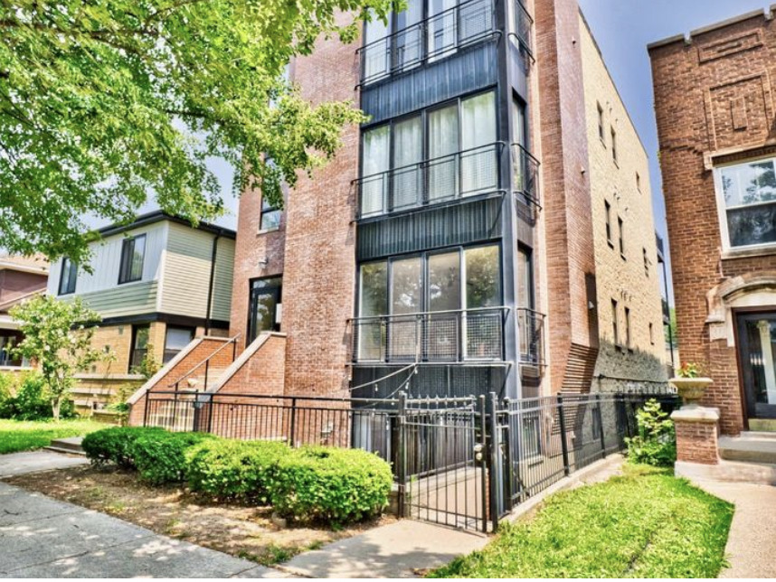 front view of a brick house with a yard